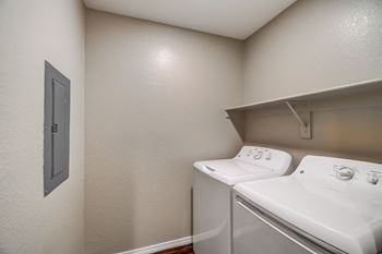 A small laundry room with a washer and dryer. at San Montego Apartments, Mesa
